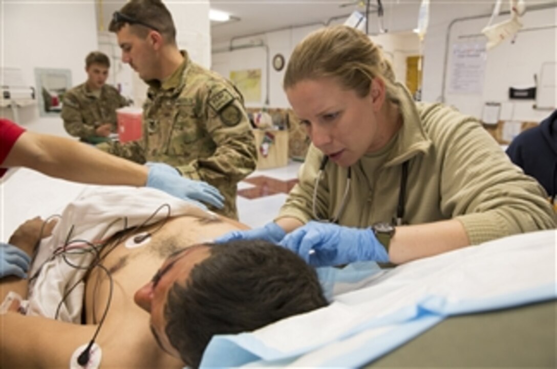 U.S. Navy Lt. j.g. Laura Cook, a physician assistant for Provincial Reconstruction Team Farah, evaluates a wounded Afghan policeman at the Forward Operating Base Farah aid station in Afghanistan on Dec. 31, 2012.  Four members of the Afghan National Police, who were wounded by an improvised explosive device, were treated by PRT Farah medical personnel, the 541st Forward Surgical Team (Airborne) and coalition force medics at the aid station.   
