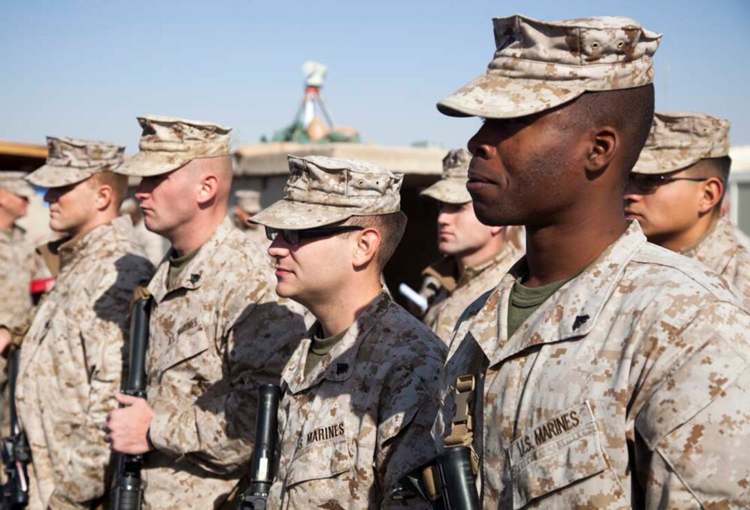 U.S. Marine Corps Cpl. Brandon C. Harper, right, with Headquarters Company, Regimental Combat Team 7 (RCT-7), stands in formation on Camp Leatherneck, Helmand province, Afghanistan, Jan. 1, 2013. The Marines and Sailors with RCT-7 are currently deployed to Afghanistan in support of Operation Enduring Freedom. (U.S. Marine Corps photo by Staff Sgt. Ezekiel R. Kitandwe/Released)
