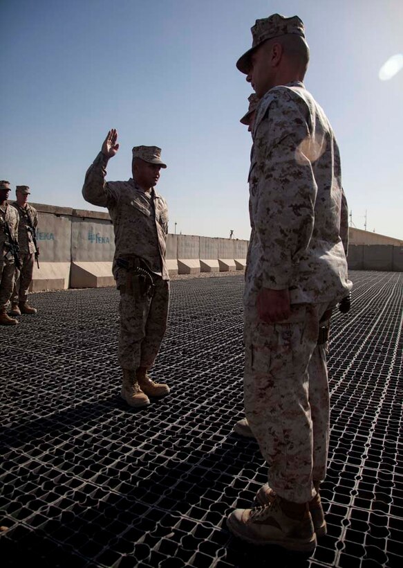 U.S. Marine Corps Staff Sgt. Sonephet Seubkanha, center, with Headquarters Company, Regimental Combat Team 7 (RCT-7), recites the Oath of Enlistment during his reenlistment ceremony on Camp Leatherneck, Helmand province, Afghanistan, Jan. 1, 2013. Seubkanha is currently deployed to Afghanistan in support of Operation Enduring Freedom. (U.S. Marine Corps photo by Staff Sgt. Ezekiel R. Kitandwe/Released)