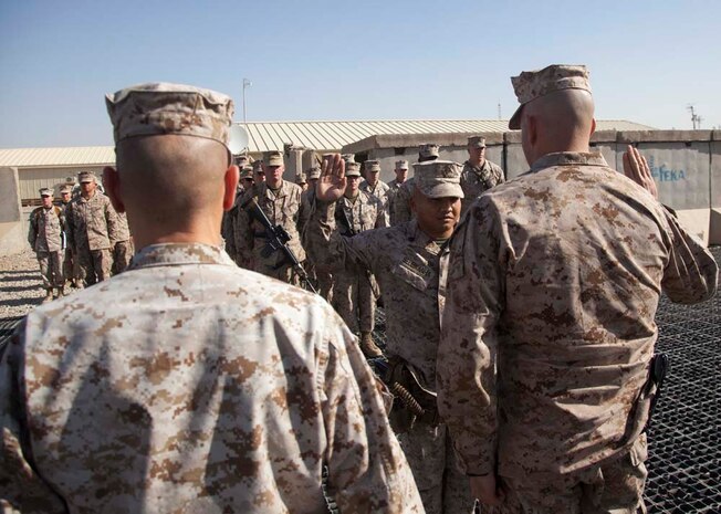 U.S. Marine Corps Staff Sgt. Sonephet Seubkanha, center, with Headquarters Company, Regimental Combat Team 7 (RCT-7), recites the Oath of Enlistment during his reenlistment ceremony on Camp Leatherneck, Helmand province, Afghanistan, Jan. 1, 2013. Seubkanha is currently deployed to Afghanistan in support of Operation Enduring Freedom. (U.S. Marine Corps photo by Staff Sgt. Ezekiel R. Kitandwe/Released)