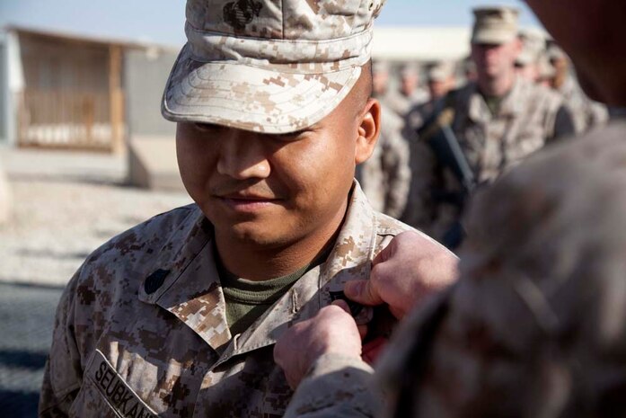 U.S. Marine Corps Gunnery Sgt. Sonephet Seubkanha (center) with Headquarters Company, Regimental Combat Team 7 (RCT-7), is promoted to his current rank on Camp Leatherneck, Helmand province, Afghanistan, Jan. 1, 2013. Seubkanha is currently deployed to Afghanistan in support of Operation Enduring Freedom. (U.S. Marine Corps photo by Staff Sgt. Ezekiel R. Kitandwe/Released)