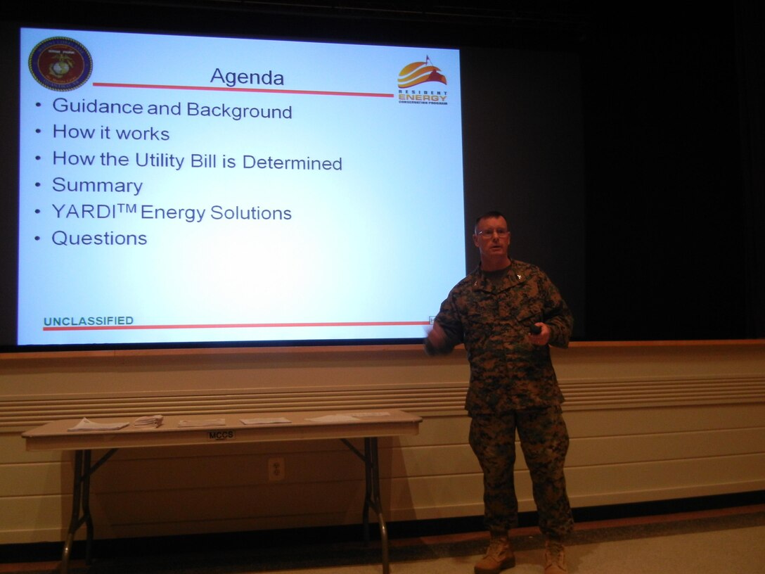 Col. David Maxwell, base commander, addresses base residents at a briefing on the upcoming Resident Energy Conservation Program on Dec. 17 at Little Hall. 