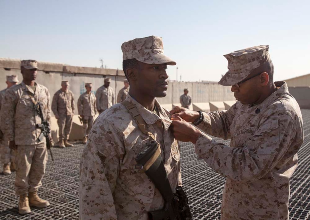U.S. Marine Corps  U.S. Marine Lance Cpl. Michael J. Garner, center, with Headquarters Company, Regimental Combat Team 7 (RCT-7), is promoted to the rank of Cpl. on Camp Leatherneck, Helmand province, Afghanistan, Jan. 1, 2013. Garner is currently deployed to Afghanistan in support of Operation Enduring Freedom. (U.S. Marine Corps photo by Staff Sgt. Ezekiel R. Kitandwe/Released)