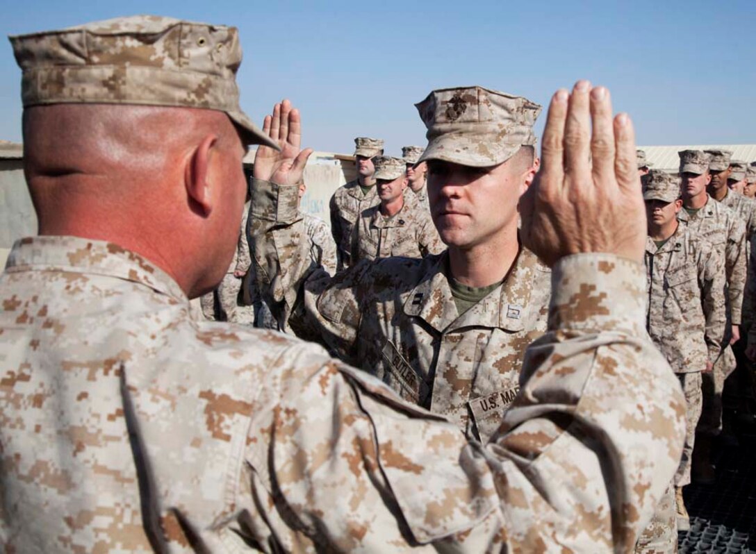 U.S. Marine Corps Capt. Dallas T. Butler (center) with Headquarters Company, Regimental Combat Team 7, recites his oath during a promotion ceremony on Camp Leatherneck, Helmand province, Afghanistan, Jan. 1, 2013. Butler is currently deployed to Afghanistan in support of Operation Enduring Freedom. (U.S. Marine Corps photo by Staff Sgt. Ezekiel R. Kitandwe/Released)