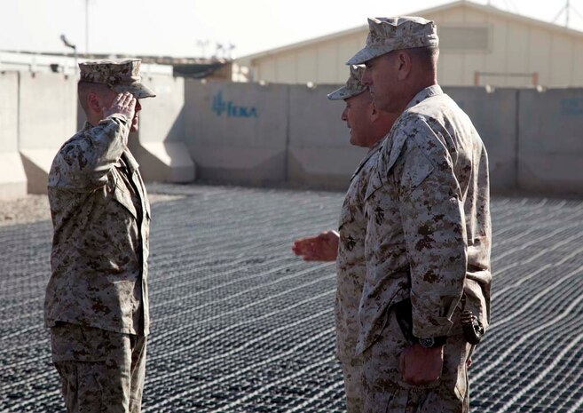 U.S. Marine Corps 1st Lt. Dallas T. Butler (left) with Headquarters Company, Regimental Combat Team 7, renders a hand salute during his promotion ceremony on Camp Leatherneck, Helmand province, Afghanistan, Jan. 1, 2013. Butler was being promoted to his current rank of Capt. (U.S. Marine Corps photo by Staff Sgt. Ezekiel R. Kitandwe/Released)