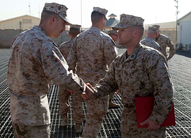 U.S. Marine Corps Capt. Dallas T. Butler (left) with Headquarters Company, Regimental Combat Team 7 (RCT-7), is congratulated by his fellow Marines after his promotion ceremony on Camp Leatherneck, Helmand province, Afghanistan, Jan. 1, 2013. Butler is currently deployed to Afghanistan in support of Operation Enduring Freedom. (U.S. Marine Corps photo by Staff Sgt. Ezekiel R. Kitandwe/Released)