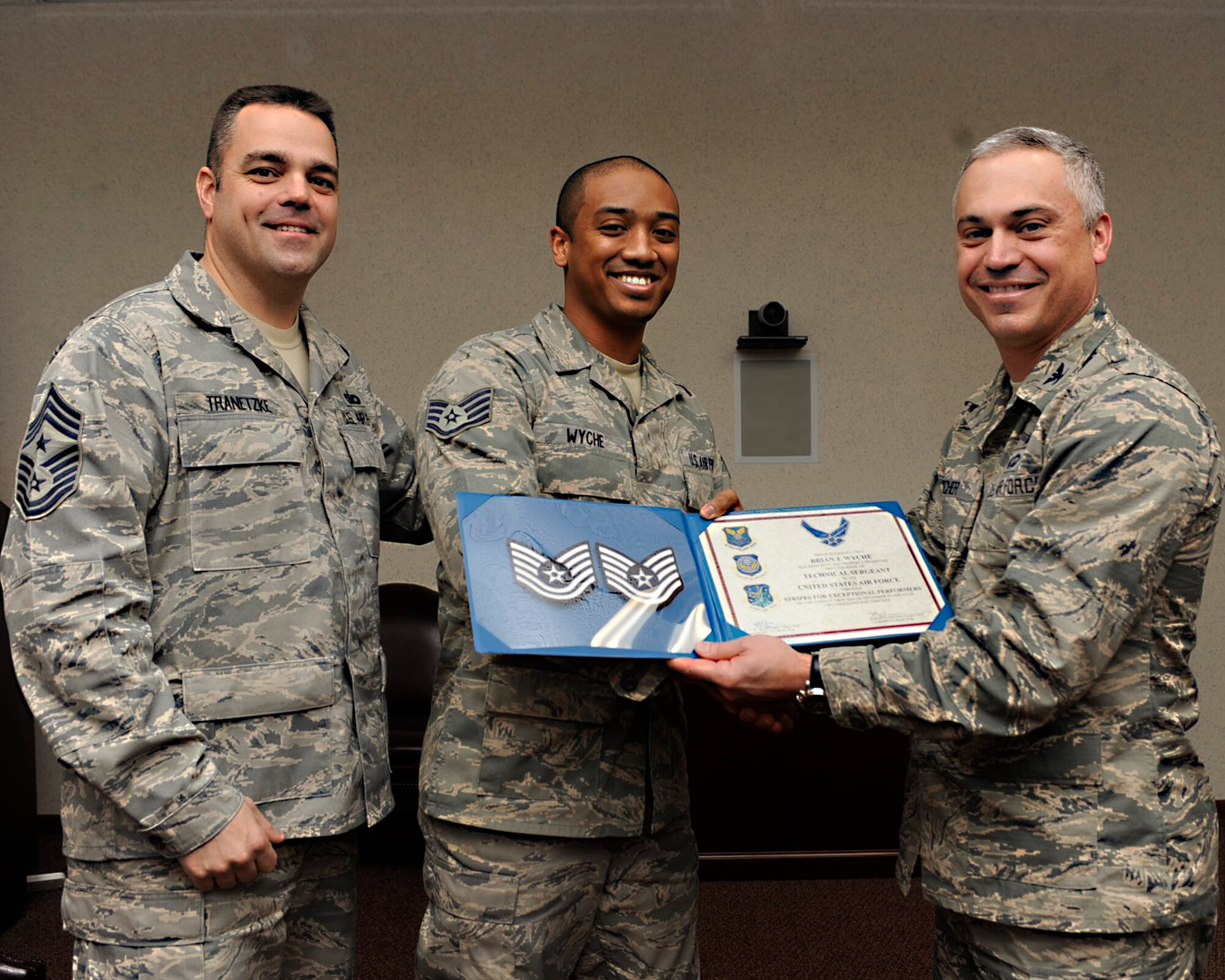 MINOT AIR FORCE BASE, N.D. -- Congratulations to Tech. Sgt. Brian Wyche, 91st Missile Wing NCOIC wing executive support, on his recent STEP promotion. Wyche is shown receiving his new stripe from Col. Robert Vercher, 91st MW commander (far right) and Chief Master Sgt. Paul Tranetzke, 91st MW command chief master sergeant. STEP, which stands for Stripes for Exceptional Performers, is a program designed to promote deserving hard chargers with average time in service compared to their peers.  (U.S. Air Force photo/ Airman 1st Class Stephanie Ashley)