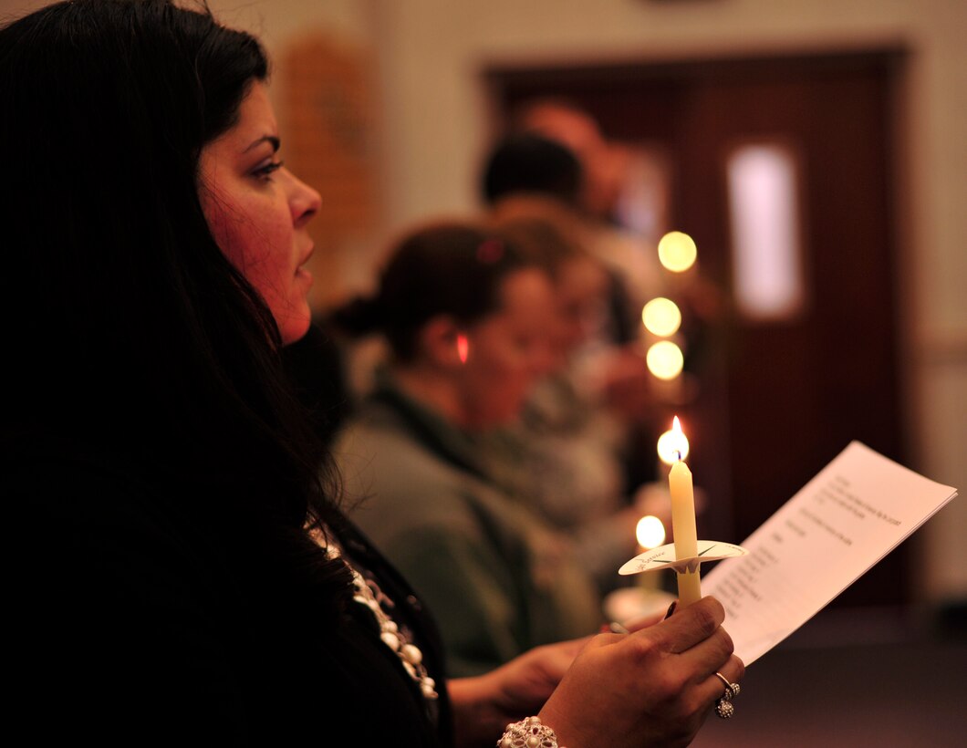 Alma Fontanez, Joint Base Andrews Protestant coordinator, reads a prayer for the victims of the Sandy Hook Elementary School shooting during a candlelight vigil at Chapel One, Dec . 19, 2012. During the event Joint Base Andrews team members lit a candle for each of the victims affected by the tragedy. (U.S. Air Force photo/ Airman 1st Class Erin O’Shea)    