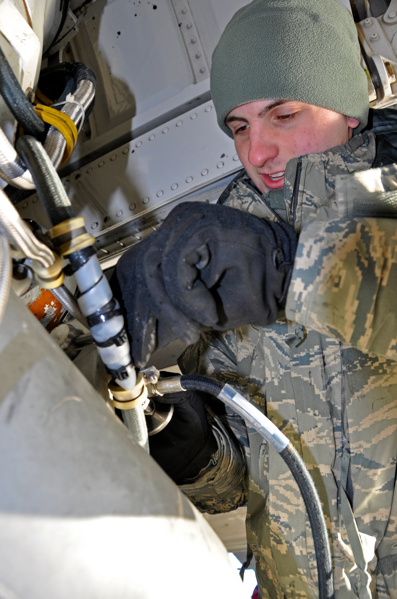 Airman Dylan Johnson, a crew chief with the 446th Aircraft Maintenance Squadron, fixes a part on a C-17 Globemaster III Jan. 3, a day with a low of 19 degrees Farenheit, on McChord Field, Wash. Maintainers like Johnson must complete their mission even in the cold, sometimes handling small tools with bulky gloves for warmth. (U.S. Air Force Photo/Staff Sgt. Rachael Garneau)