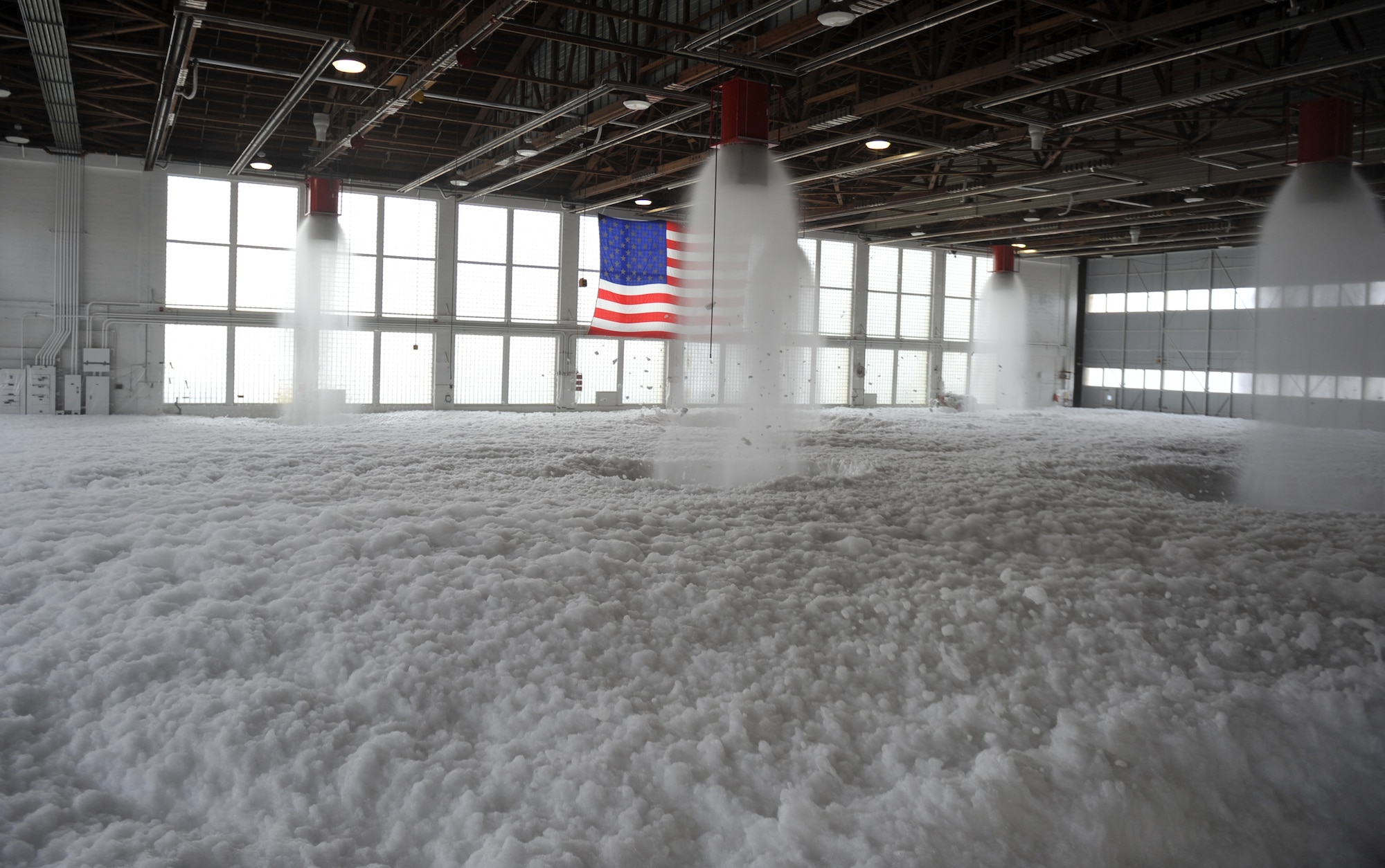Aqueous Film Forming Foam, or AFFF, fills Hangar 211 Dec. 21, 2012, at Mountain Home Air Force Base, Idaho. Personnel from the 366th Civil Engineering Squadron performed the test to ensure aircraft maintainers who work inside this hangar will have a safe place to perform their operations – in the event of a fire the system will protect the Airmen and equipment. (U.S. Air Force photo/Senior Airman Heather Hayward) 
