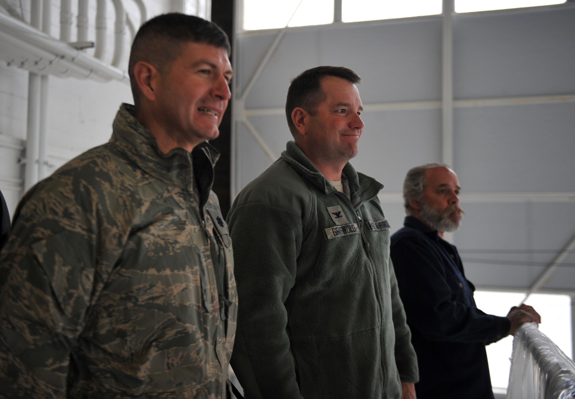 U. S. Air Force Col. Steven Griswold, 366th Mission Support Group commander, and Lt. Col. Eric Fajardo, 366th Civil Engineering Squadron commander, watch while foam is dispensed inside Hangar 211 Dec. 21, 2012, at Mountain Home Air Force Base, Idaho. The Aqueous Film Forming Foam or AFFF is designed to engulf and suffocate a fire by depriving it of oxygen. (U.S. Air Force photo/Senior Airman Heather Hayward)