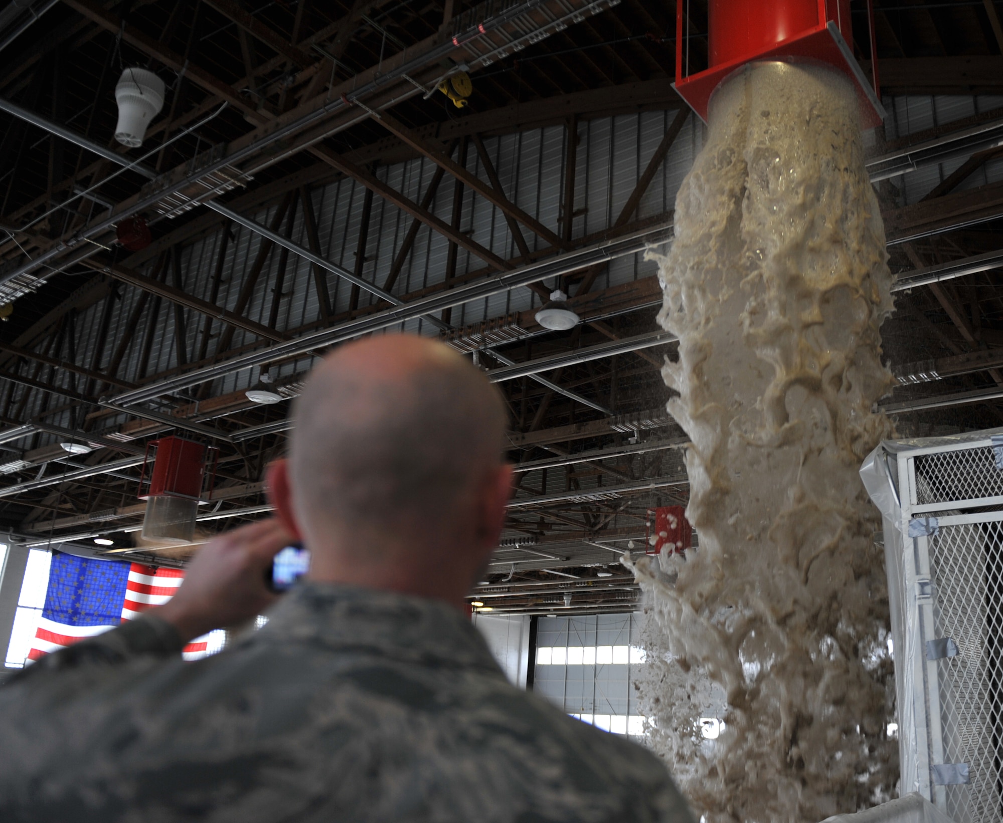 Foam pours out of a dispenser generator inside Hangar 211 Dec. 21, 2012, at Mountain Home Air Force Base, Idaho. Every two years, Airmen are required to test the fire suppression systems in order to protect people and equipment. (U.S. Air Force photo/Senior Airman Heather Hayward)