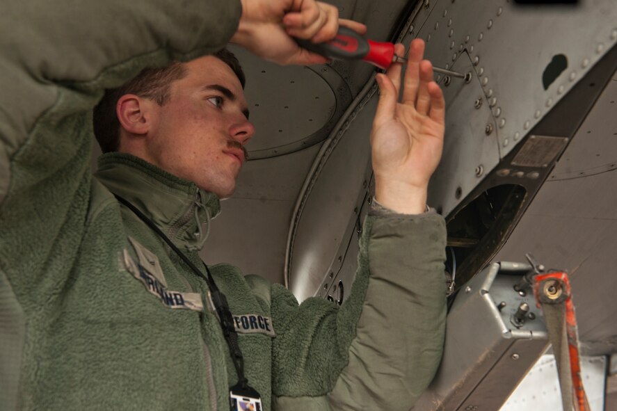 U.S. Air Force Airman 1st Class Nathan Durland, 75th Aircraft Maintenance Unit weapons load crew member, tightens screws on an A-10C Thunderbolt II during a maintenance check at Moody Air Force Base, Ga., Jan. 3, 2013. The check ensured the aircraft was in top shape before flight. (U.S. Air Force photo by Airman Alexis Grotz/Released)