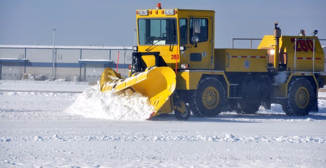 An Allegheny County Airport Authority snow plow clears a runway used by the 911th Airlift Wing, Jan.  3, 2012. The Allegheny County Airport Authority supports the 911th AW with 24/7 emergency and fire rescue services, air traffic control tower operations, snow removal and runway maintenance as part of the land lease agreement with nominal cost to the U.S. Air Force Reserve. (U.S. Air Force photo by Senior Airman Joseph E. Bridge/Released)