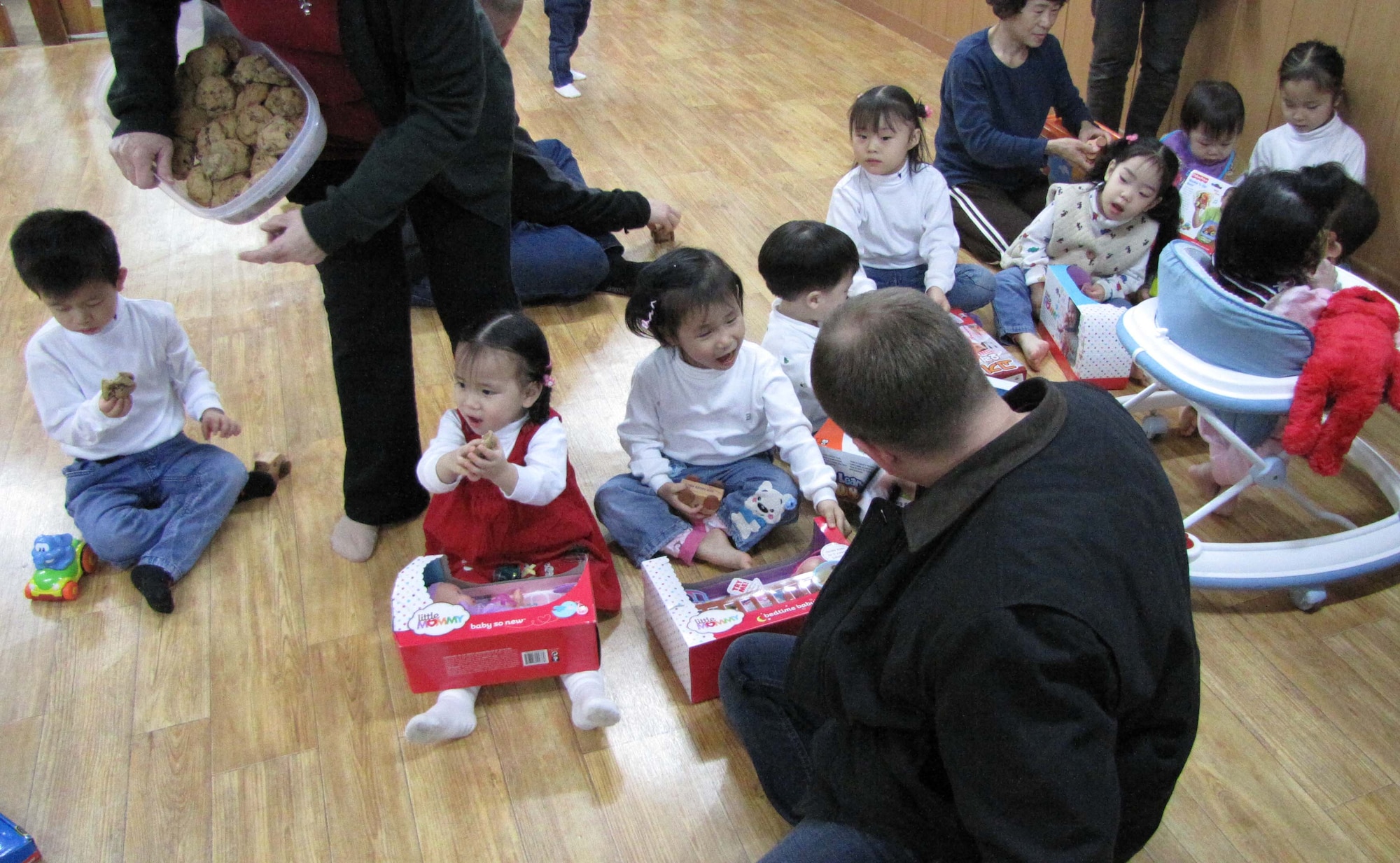 Boys and girls from the Chechon Children's Home in South Korea are elated to receive gifts from members of the Air Force Technical Applications Center's Detachment 452 based in Wonju, S. Korea.  Detachment personnel collected donations, including hand-carved toy cars from Ed Wares, father of Sabrina Miller, AFTAC's Scientific & Technical Information Program Manager.  The orphanage welcomes donations to improve the quality of life for the children and help offset costs for things like life skills seminars for young adults when they transition from the orphanage into Korean society. (Courtesy photo)