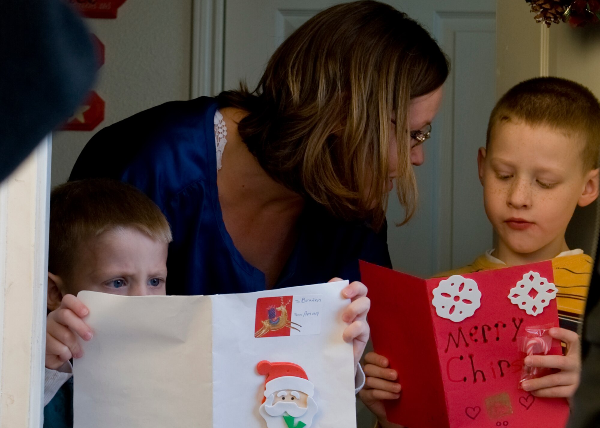 Braden Cameron, 3, and Dakota Cameron, 6, read their Christmas cards from members of Operation Youth Outreach Dec. 13, 2012, at Dyess Air Force Base, Texas. The program’s mission is for youth to help youth. The personalized cards were written by Dyess youth to let children of deployed servicemembers know that they’re being thought of during the holidays and that they’re not alone. More than 20 cards were created, each one with its own special touch and message. (U.S. Air Force photo by Airman 1st Class Damon Kasberg/ Released)