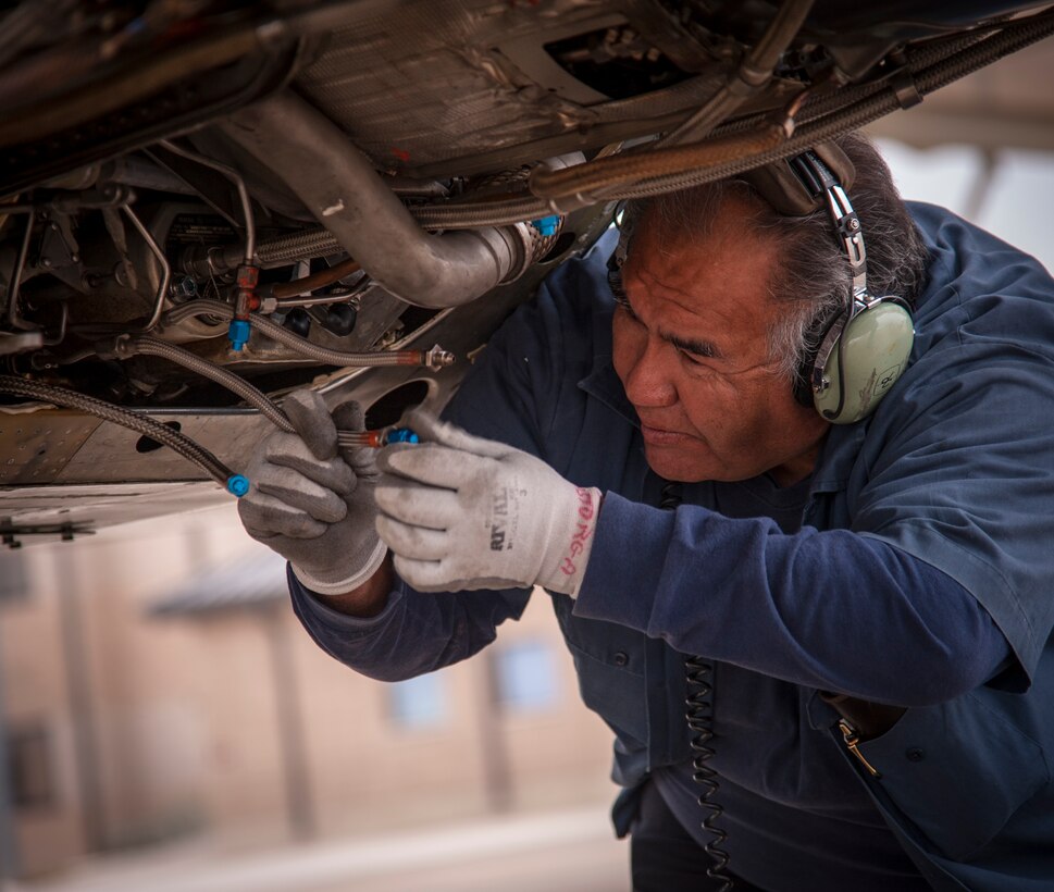 David Astorga, 47th Maintenance Directorate, caps the drain lines on a T-38 Talon while performing maintenance work on the aircraft’s engines at Laughlin Air Force Base, Texas, Jan. 3, 2013. The Air Force’s busiest airfield resumed operating Jan. 2, 2013 after a short break for the holidays. (U.S. Air Force photo/Airman 1st Class Nathan Maysonet)    