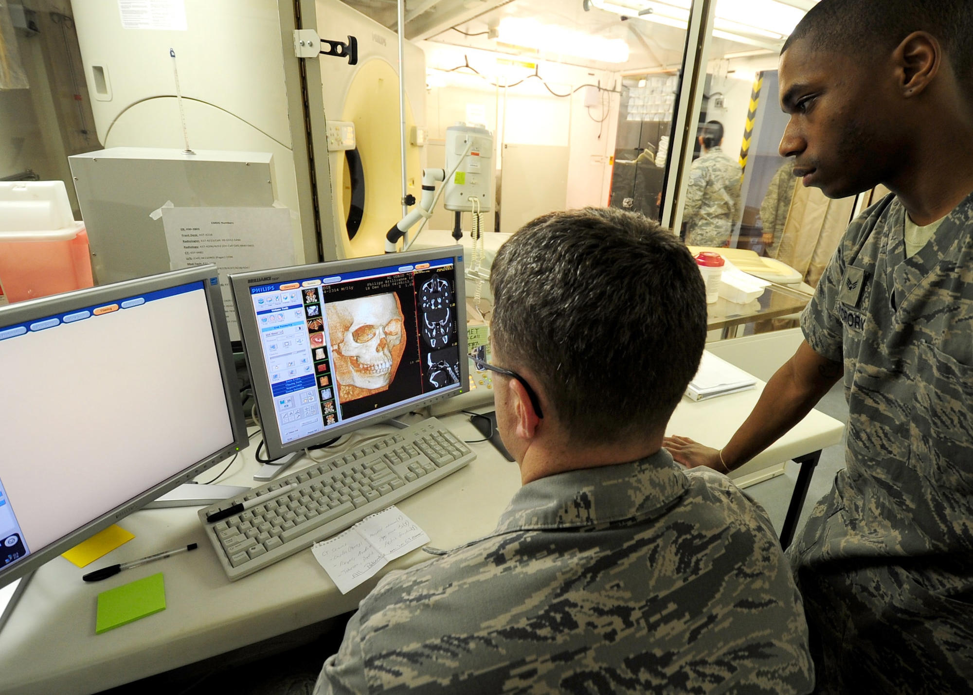 SOUTHWEST ASIA – Maj. (Dr.) Douglas Vanderkooi and Senior Airman Edward McCrory examine a three-dimensional view of a facial fracture taken using the computed tomography scan unit. The CT takes hundreds of three-dimensional images that permit medics to see inside the human body in high detail. Both Airmen are assigned to the 379th Expeditionary Medical Group. (U.S. Air Force photo/Master Sgt. Brendan Kavanaugh)