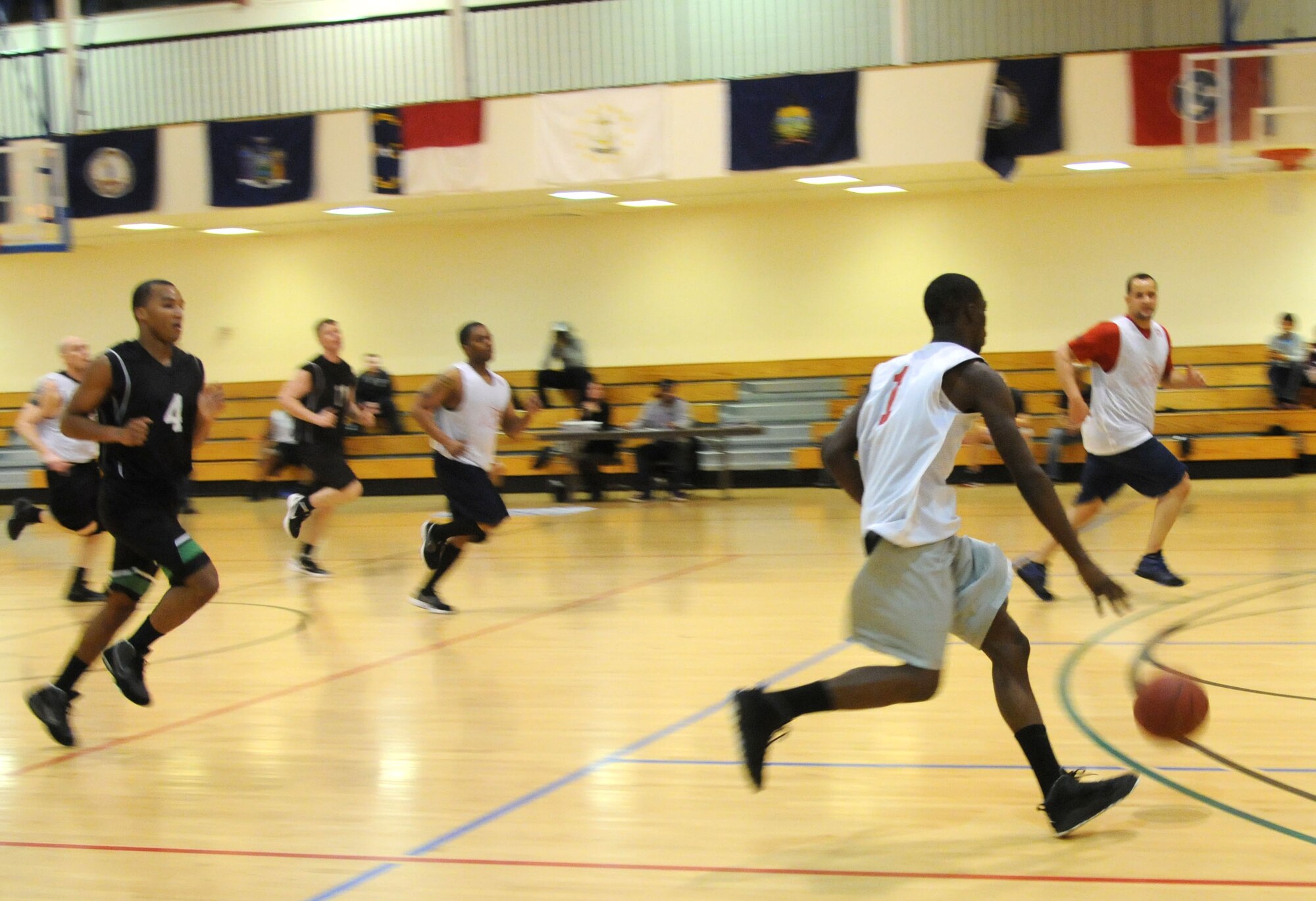 A player from the 100th Maintenance Group dribbles the basketball down the court during a game against the 352nd Special Operations Support Squadron Jan. 3, 2013, at the Hardstand Fitness Center on RAF Mildenhall, England. The 100th MXG team went on to win the game 59-32. The intramural basketball season will continue through the end of February.  (U.S. Air Force photo by Airman 1st Class Kelsey Waters/Released)