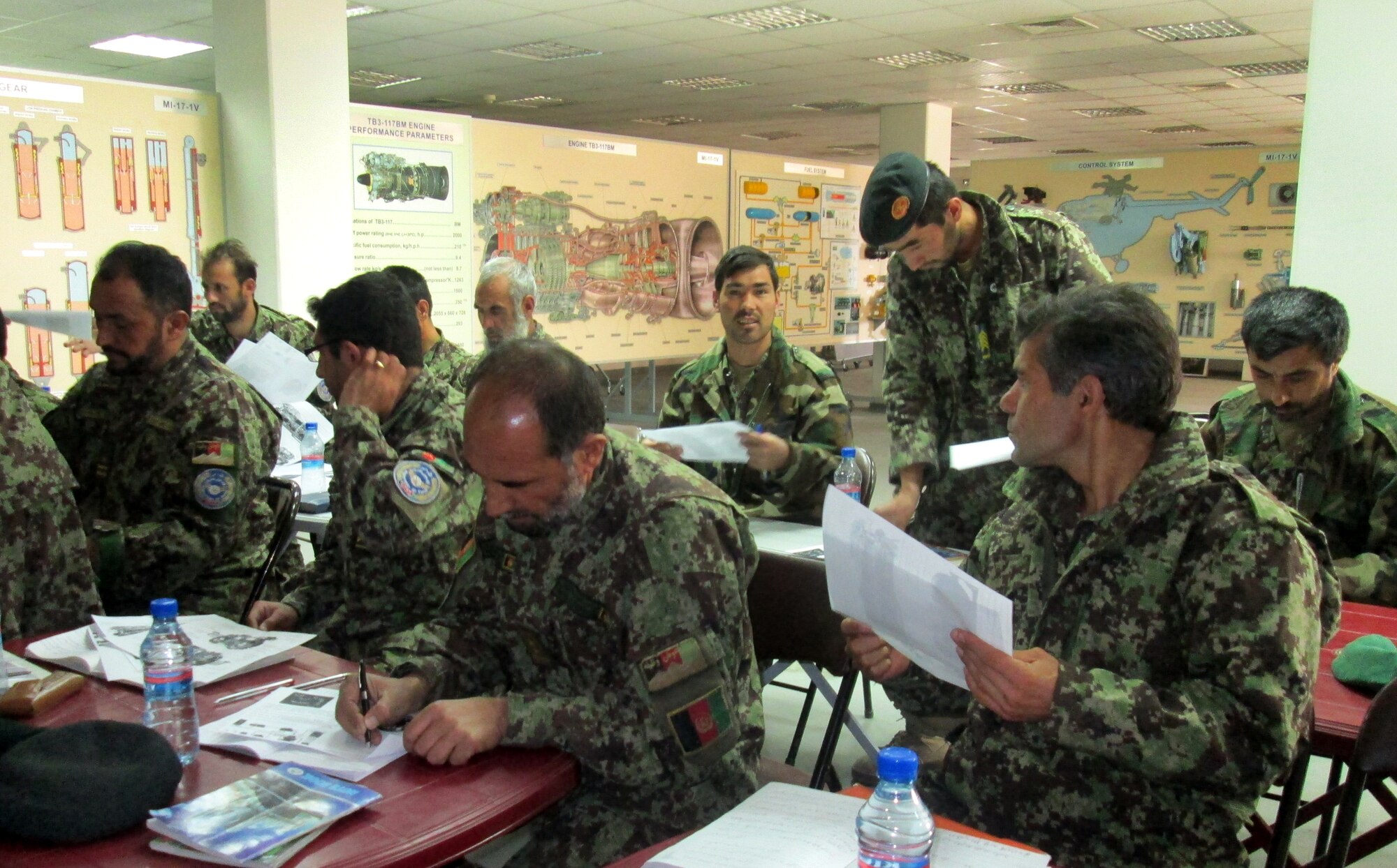 Afghan Air Force students work on class materials during an eleven week Mi-17 helicopter ‘Engine & Body’ maintenance course at Kabul, Afghanistan, International Airport Nov. 11, 2012. Afghan course instructors partnered with Mongolian Air Force mentors to conduct the class. The Afghan AF’s newest 16 Mi-17 helicopter technicians crossed a stage Dec. 20, 2012 at the airport. (Courtesy photo)