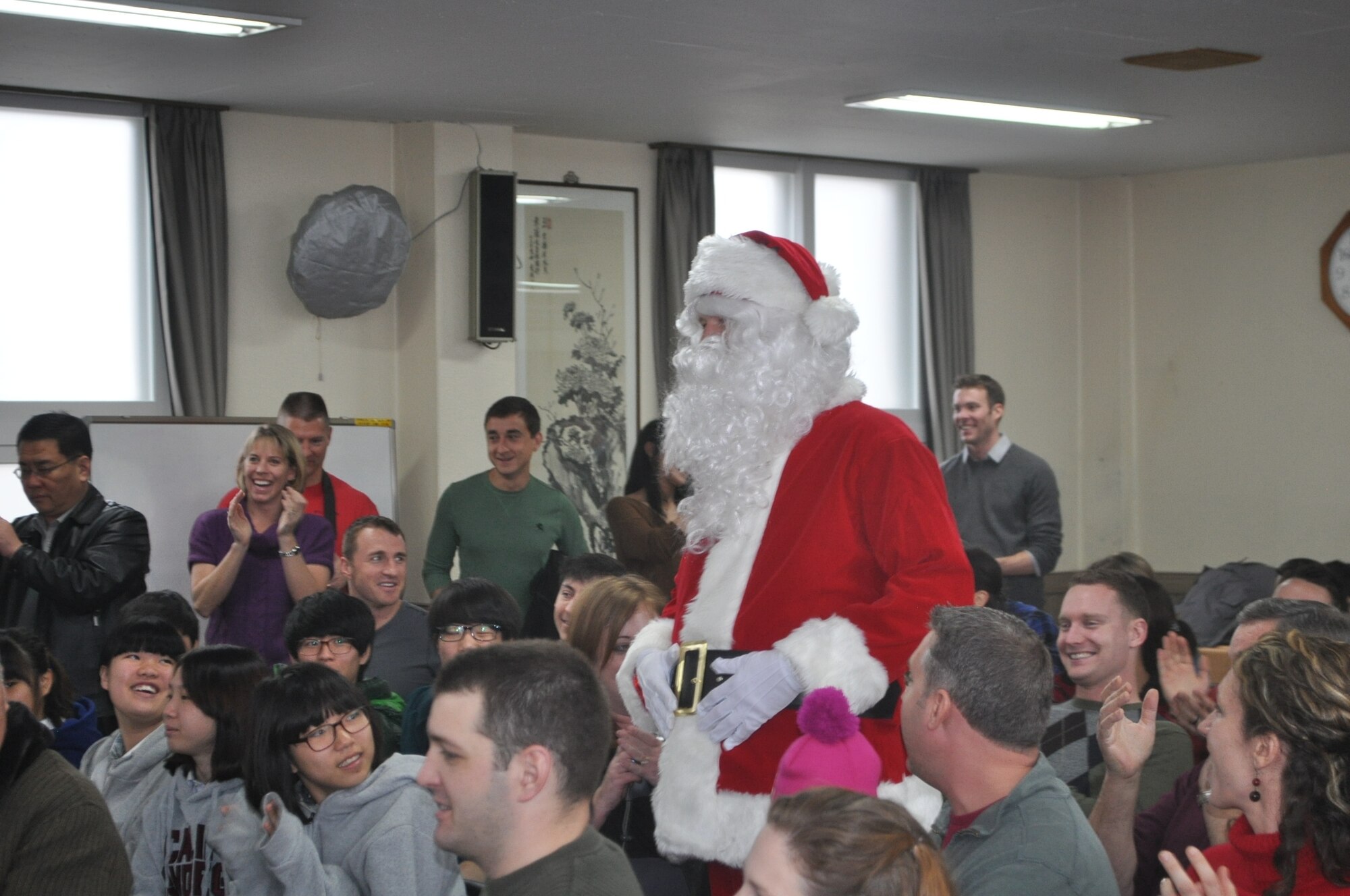 Members of the 36th Fighter Squadron and children from the Ae Hyang Child Welfare Center in Pyeongtaek welcome Santa during a visit to the orphanage Dec. 15, 2012. The 36th Fighter Squadron has been participating in the Ae Hyang Christmas Party since the 1980s. (courtesy photo)