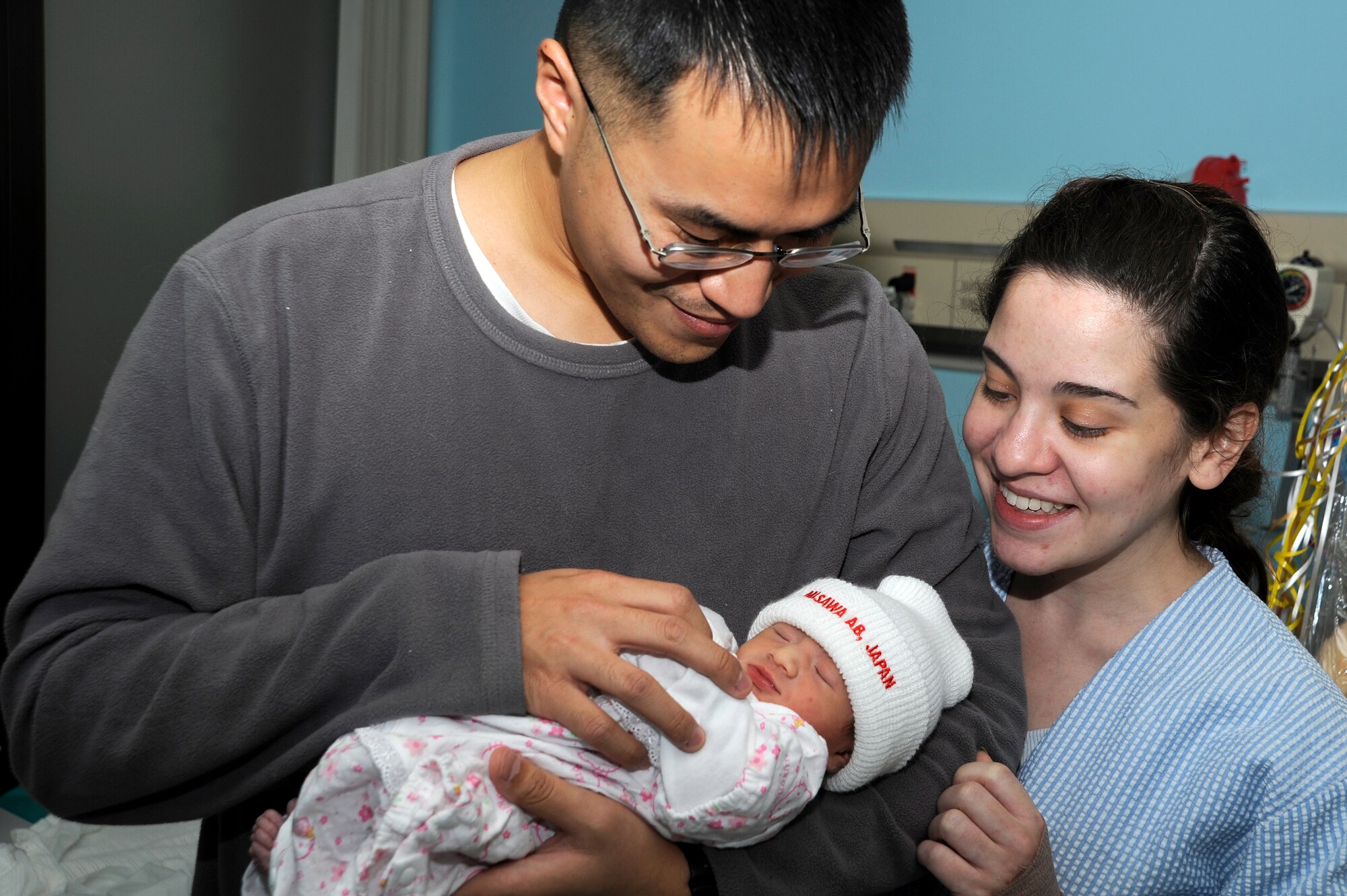 Staff Sgt. Shangjung Chiu, 35th Maintenance Operations Squadron, production analyst, and his wife Christi-June, admire their infant daughter, Evangeline, at Misawa Air Base, Japan, Jan. 4. The new family will be heading home from the base hospital on Jan. 5. (U.S. Air Force photo by Tech. Sgt. Marie Brown)
