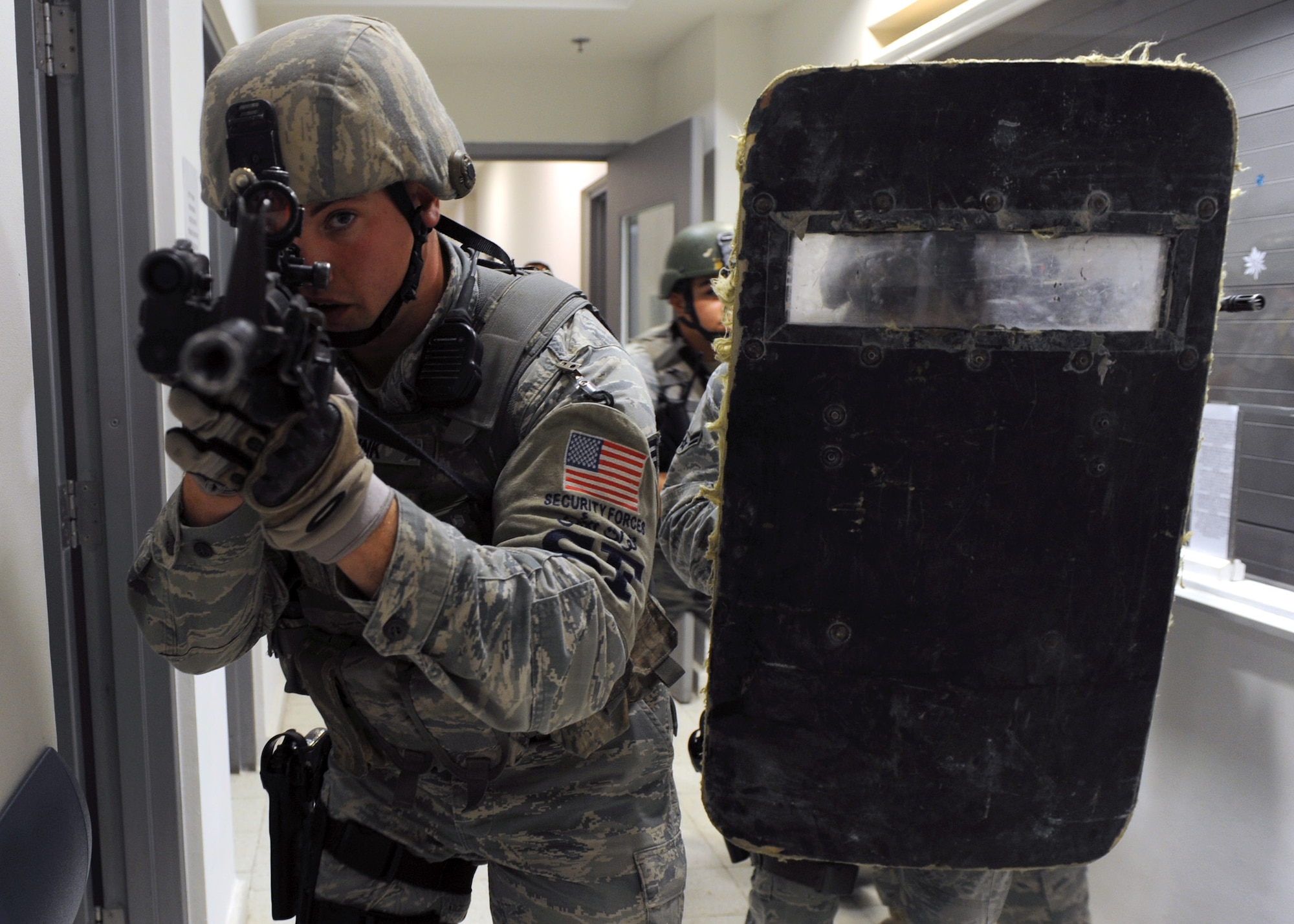 SOUTHWEST ASIA – Airmen assigned to the 379th Expeditionary Security Forces Squadron storm the hallways of the 379th Expeditionary Medical Group clinic to neutralize an active shooter during a training scenerio Dec. 28. Service members have three choices when confronted with an acitve shooter escape, barricade or fight; only two possible outcomes, live or die; and only one chance to get it right. (U.S. Air Force photo/Senior Airman Joel Mease)
