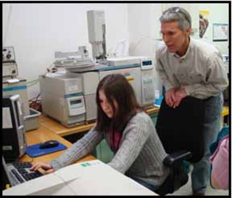 In the soil microbiology lab, ERDC Cold Regions Research and Engineering Laboratory (CRREL) Scientist David Ringelberg instructs a Job Shadow student on the use of a mass spectrometer, a piece of equipment that helps scientists determine the composition of certain compounds.