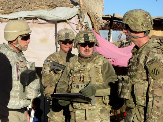 From the left: Eric Milstrey, USAID District Stability team lead for Maiwand, Alan Avery, U.S. Army Corps of Engineers 565th Forward Engineer Support Team-Advance, and Lt. Col. Robert Bensburg, Regional Command-South Stability Division, Infrastructure officer in charge, discuss a proposed electric utility improvement project in Kandahar Province, Afghanistan, Nov. 29, 2012.