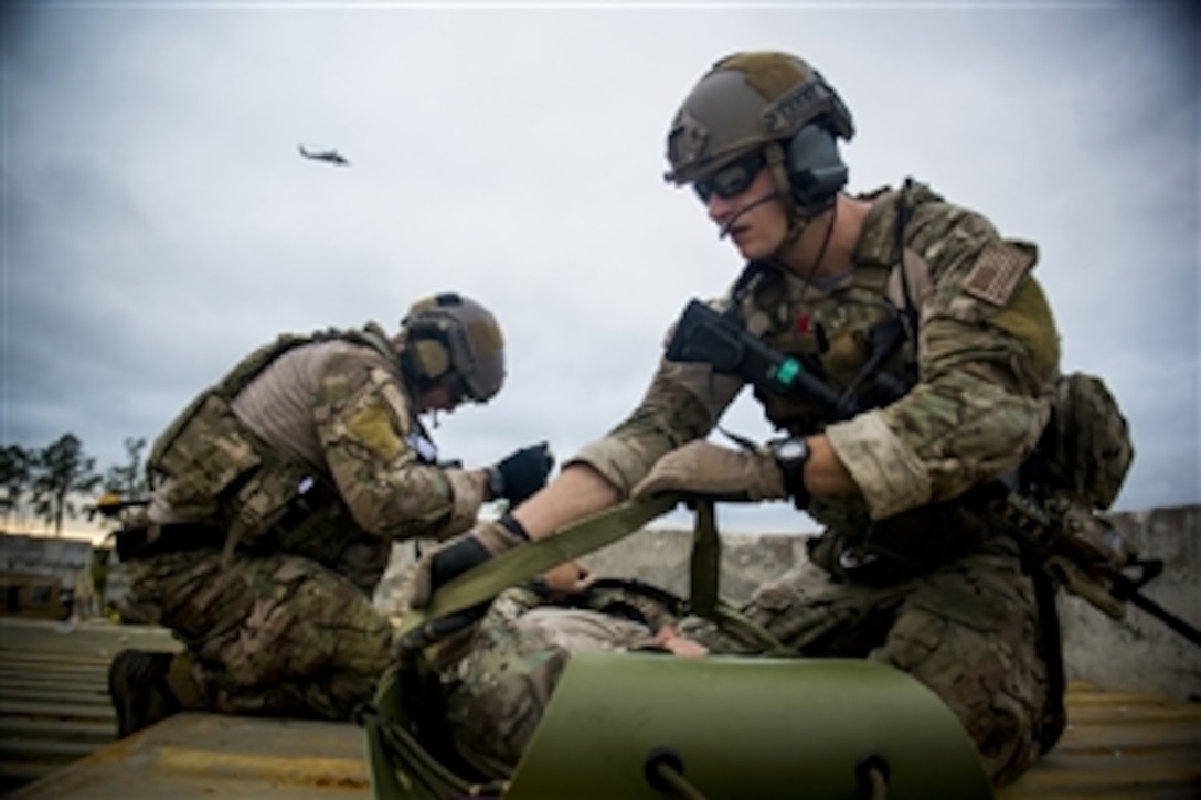 U.S. Air Force Staff Sgts. Eric Braddock, left, and Ryan Onely prepare a simulated casualty for a medical evacuation during a training mission at Avon Park Air Force Range, Fla., on Dec. 13, 2012.  Braddock and Onely are pararescuemen assigned to the 38th Rescue Squadron.  