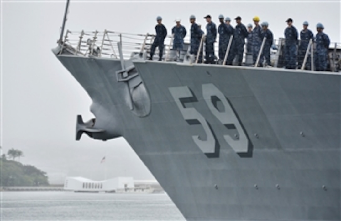 Crewmembers man the rail as the guided-missile destroyer USS Russell (DDG 59) departs Joint Base Pearl Harbor-Hickam for the last time while home ported in Hawaii on Jan. 3, 2013.  The crew is scheduled to swap hulls with the guided-missile destroyer USS Halsey (DDG 97) in late January.  
