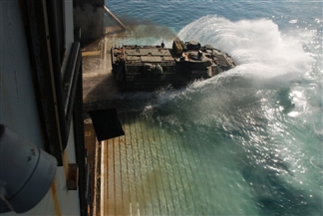 A U.S. Marine Corp amphibious assault vehicle splashes into the sea as it departs the amphibious transport dock ship USS Green Bay (LPD 20) on Dec. 19, 2012.  Green Bay as part of the Peleliu Amphibious Ready Group and with the embarked 15th Marine Expeditionary Unit are deployed to the 5th Fleet area of responsibility to conduct maritime security operations and theater security cooperation efforts.  