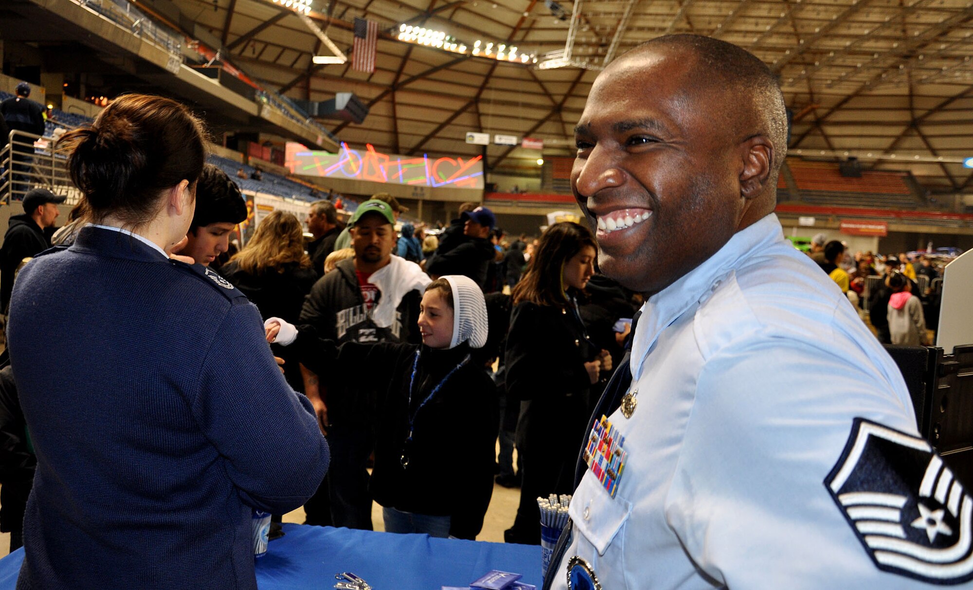 Master Sgt. Ed Norris Jr., an in-service recruiter with the 446th reserve recruiting, works the crowd at Monster Jam at the Tacoma Dome Jan. 5, 2013. Norris and other recruiters man the table and answer any questions guests have about joining the Air Force Reserve. (U.S. Air Force Photo/Airman 1st Class Madelyn McCullough)