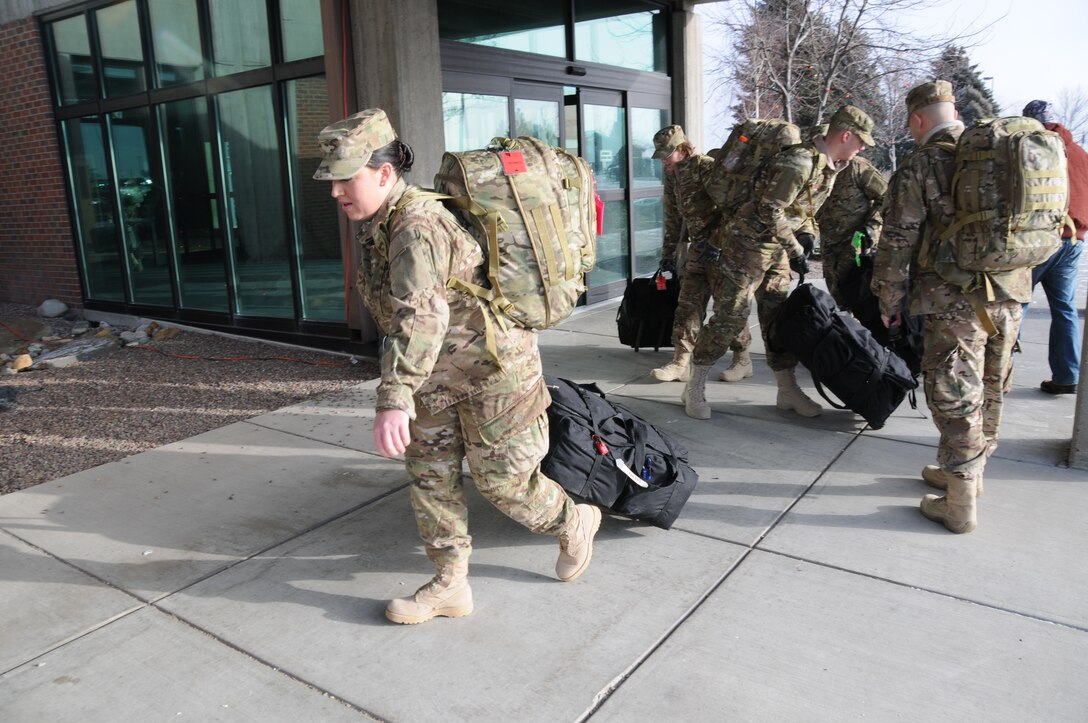 Deploying 120th Security Forces Squadron member Senior Airman Amanda Schmidt brings her bags into the Great Falls International Airport on Dec. 23, 2012.  National Guard photo by Senior Master Sgt. Eric Peterson.