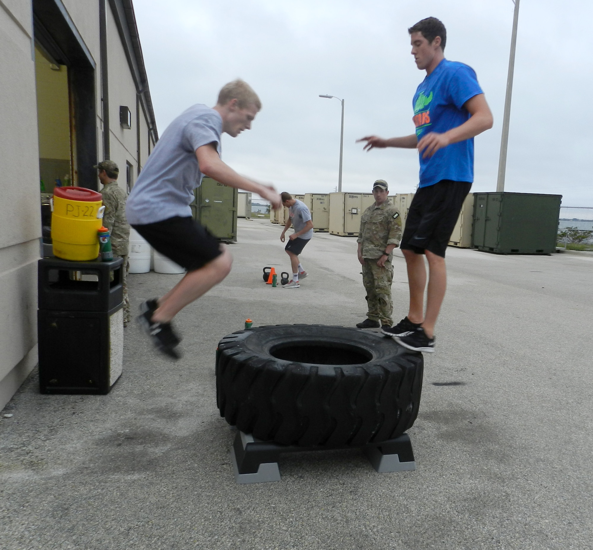 Capt. James Sluder, Air Force Reserve combat rescue officer, looks on as a member of the University of Florida team member and Olympian Conor Dwyer complete their 24" box jumps during their workout. The UF swimmers and Olympians were treated to a grueling day of workouts put together by the Guardian Angels from the 920th Rescue Wing, Patrick Air Force Base, Cocoa Beach, Fla. (U.S. Air Force photo/2nd Lt. Leslie Forshaw)
