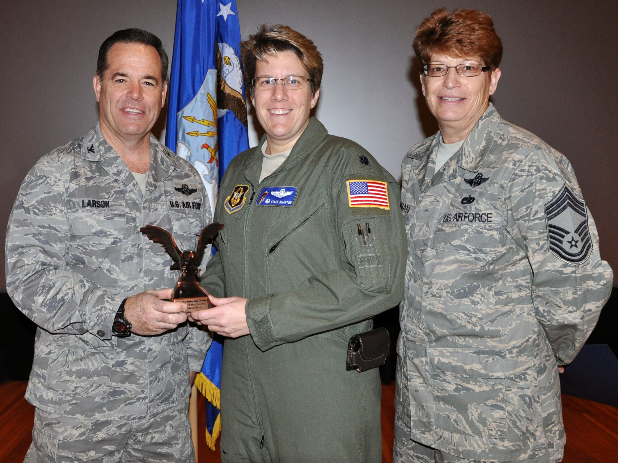 Col. Mark S. Larson, commander of the 931st Air Refueling Group, and Chief Master Sgt. Kathleen E. Lowman, 931st Air Refueling Group superintendent, present the Civilian of the Quarter for the 4th quarter of 2012 award to Lt. Col. Stacy Wharton during the 931st Air Refueling Group commander's call at McConnell Air Force Base, Kan, Jan. 6, 2013.  Wharton accepted the award on behalf of Mrs. Miranda Beyer who was unable to attend the ceremony.  (U.S. Air Force photo by 1st Lt. Zach Anderson)