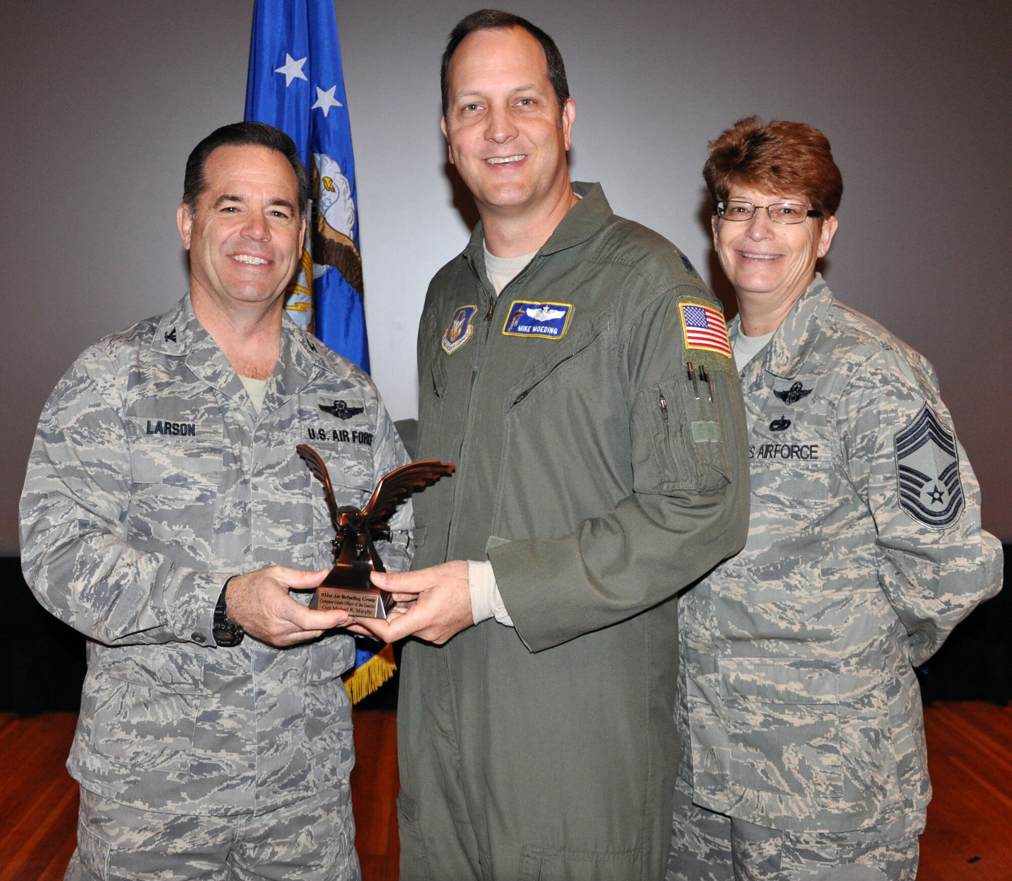 Col. Mark S. Larson, commander of the 931st Air Refueling Group, and Chief Master Sgt. Kathleen E. Lowman, 931st Air Refueling Group superintendent, present the Company Grade Officer of the Quarter for the 4th quarter of 2012 award to Lt. Col. Mike Moeding during the 931st Air Refueling Group commander's call at McConnell Air Force Base, Kan, Jan. 6, 2013.  Moeding accepted the award on behalf of Capt. Michael Murphy who was unable to attend the ceremony.  (U.S. Air Force photo by 1st Lt. Zach Anderson)