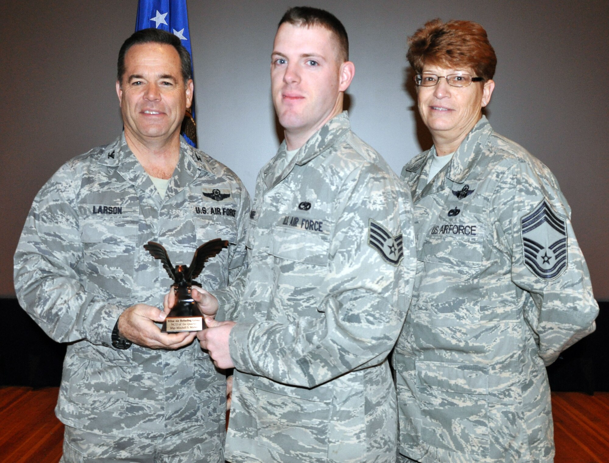 Col. Mark S. Larson, commander of the 931st Air Refueling Group, and Chief Master Sgt. Kathleen E. Lowman, 931st Air Refueling Group superintendent, congratulate Staff Sgt. Mitchell Mabee as Noncomissioned Officer of the Quarter for the 4th quarter of 2012 during the 931st Air Refueling Group commander's call at McConnell Air Force Base, Kan, Jan. 6, 2013.  (U.S. Air Force photo by 1st Lt. Zach Anderson)