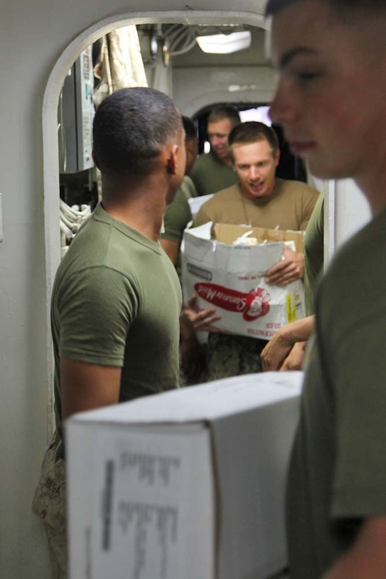 Marines and sailors aboard the USS Rushmore conduct a replenishment-at-sea, Dec. 5. The 15th Marine Expeditionary Unit is deployed as part of the Peleliu Amphibious Ready Group as a U.S. Central Command theater reserve force, providing support for maritime security operations and theater security cooperation efforts in the U.S. 5th Fleet area of responsibility. (U.S. Marine Corps photo by Cpl. Timothy R. Childers)