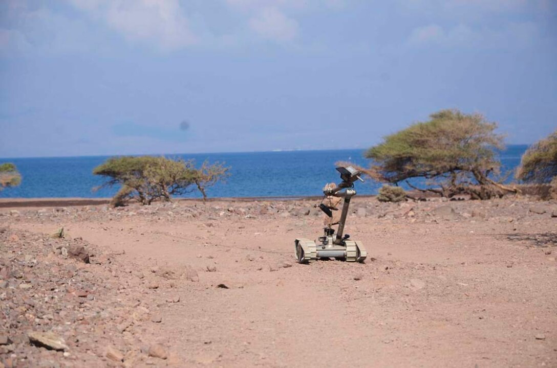 Marines assigned to Explosive Ordnance Detachment, 15th Marine Expeditionary Unit (MEU), employ a PAC Robot to detect improvised explosive devices during a practice sustainment training scenario at Port Arta, Djibouti, Dec. 12. 15th MEU is deployed as part of the Peleliu Amphibious Ready Group as a U.S. Central Command theater reserve force, providing support for maritime security operations and theater security cooperation efforts in the U.S. 5th Fleet area of responsibility. (U.S. Marine Corps photo by Cpl. Richard Sanglap-Heramis/Released)