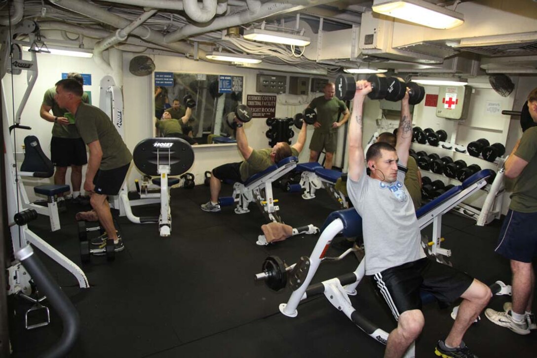 Marines assigned to the 15th Marine Expeditionary Unit work out in one of the gyms aboard the USS Rushmore, Dec. 27. The 15th MEU is deployed as part of the Peleliu Amphibious Ready Group as a U.S. Central Command theater reserve force, providing support for maritime security operations and theater security cooperation efforts in the U.S. 5th Fleet area of responsibility. (U.S. Marine Corps photo by Cpl. Timothy R. Childers)