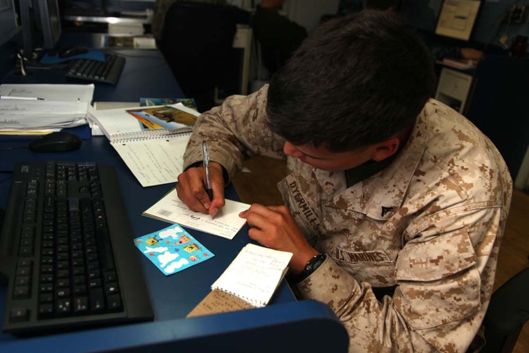 Lance Cpl. Jacob F. Dyermills, heavy equipment operator, Engineer Detachment, Combat Logistics Battalion 15, 15th Marine Expeditionary Unit, writes a Christmas letter home from the USS Rushmore, Dec. 27. The 15th MEU is deployed as part of the Peleliu Amphibious Ready Group as a U.S. Central Command theater reserve force, providing support for maritime security operations and theater security cooperation efforts in the U.S. 5th Fleet area of responsibility. (U.S. Marine Corps photo by Cpl. Timothy R. Childers)