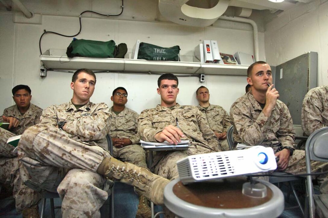 Marines assigned to the 15th Marine Expeditionary Unit attend a U.S. History class aboard the USS Rushmore, Dec. 28. Marines and sailors aboard the Rushmore use the Tuition Assistance Program to enroll in courses offered by Central Texas College and Park University. The 15th MEU is deployed as part of the Peleliu Amphibious Ready Group as a U.S. Central Command theater reserve force, providing support for maritime security operations and theater security cooperation efforts in the U.S. 5th Fleet area of responsibility. (U.S. Marine Corps photo by Cpl. Timothy R. Childers)