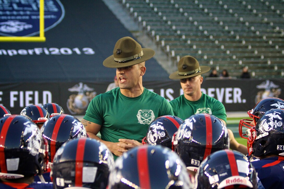Drill instructors from Marine Corps Recruit Depot San Diego motivate players with the East Coast team during the Semper Fidelis All-American Bowl Jan. 4, 2013. The Semper Fidelis Bowl is unique because it brings together some of the nations top high school student athletes who excel not only on the field but in the classroom and in their communities as well.