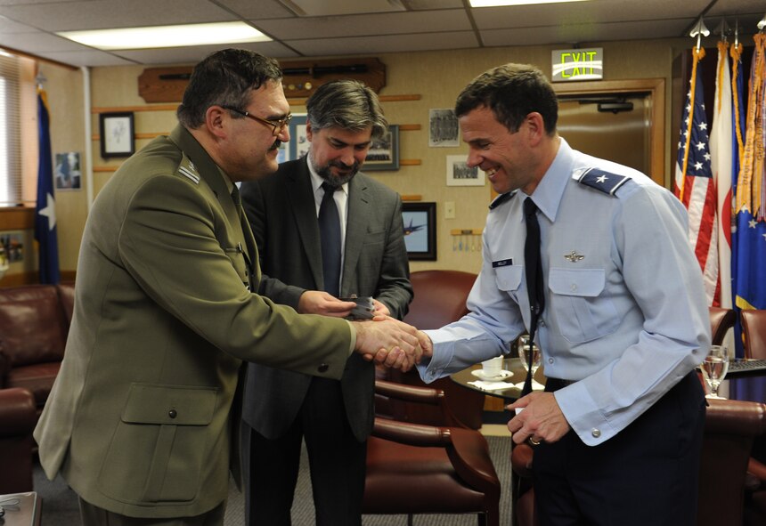 U.S. Air Force Brig. Gen. Matt Molloy, 18th Wing commander, receives a coin from Col. Krzysztof Rengel during his visit to Kadena Air Base, Japan, Jan. 7, 2013. Molloy explained the history of Okinawa and the unique capabilities of Kadena to Rengel and Cyryl Kozaczewski, Ambassador Extraordinary and Plenipotentiary of the Republic of Poland to Japan, during their tour of the base. (U.S. Air Force photo/Airman 1st Class Malia Jenkins)   