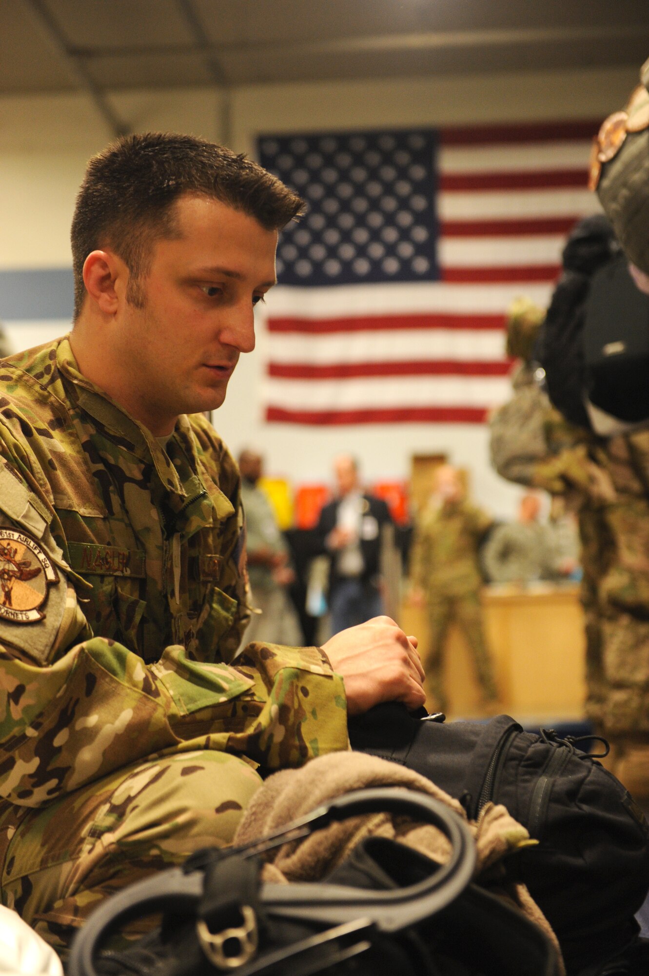 Staff Sgt. Brian Nagler, a 61st Airlift Squadron flight engineer, repacks his luggage Jan. 6, 2013, at Little Rock Air Force Base, Ark. Nagler double checked his luggage for any knives or sharp objects. (U.S. Air Force photo by Airman 1st Class Ethan Dunagan)