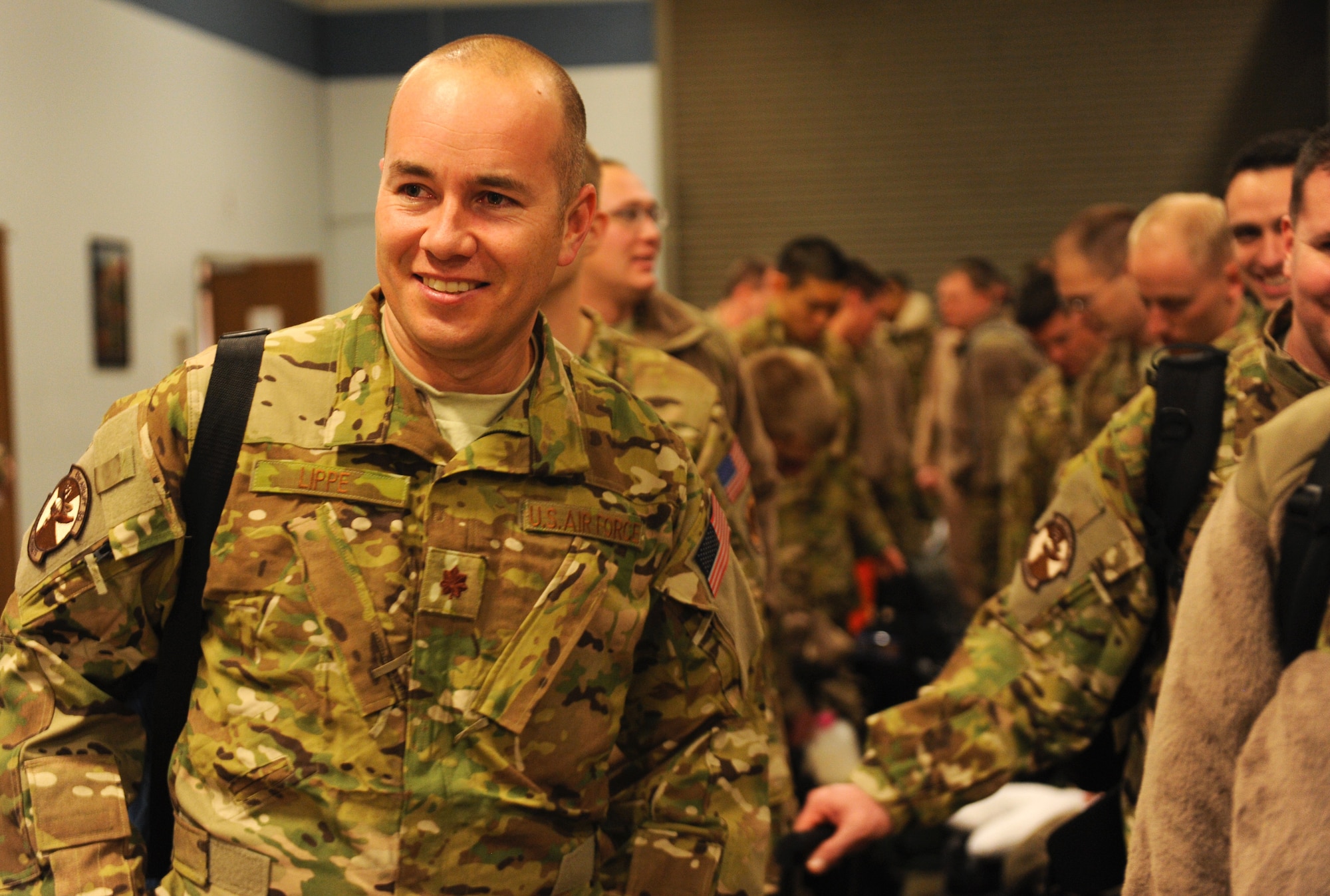Maj. Joe Lippe, a 61st Airlift Squadron pilot, waits in line to get weighed in Jan 6, 2013, at Little Rock Air Force Base, Ark. Military members weight is recorded to ensure that the plane is light enough to lift off during take-off. (U.S. Air Force photo by Airman First Class Ethan Dunagan)