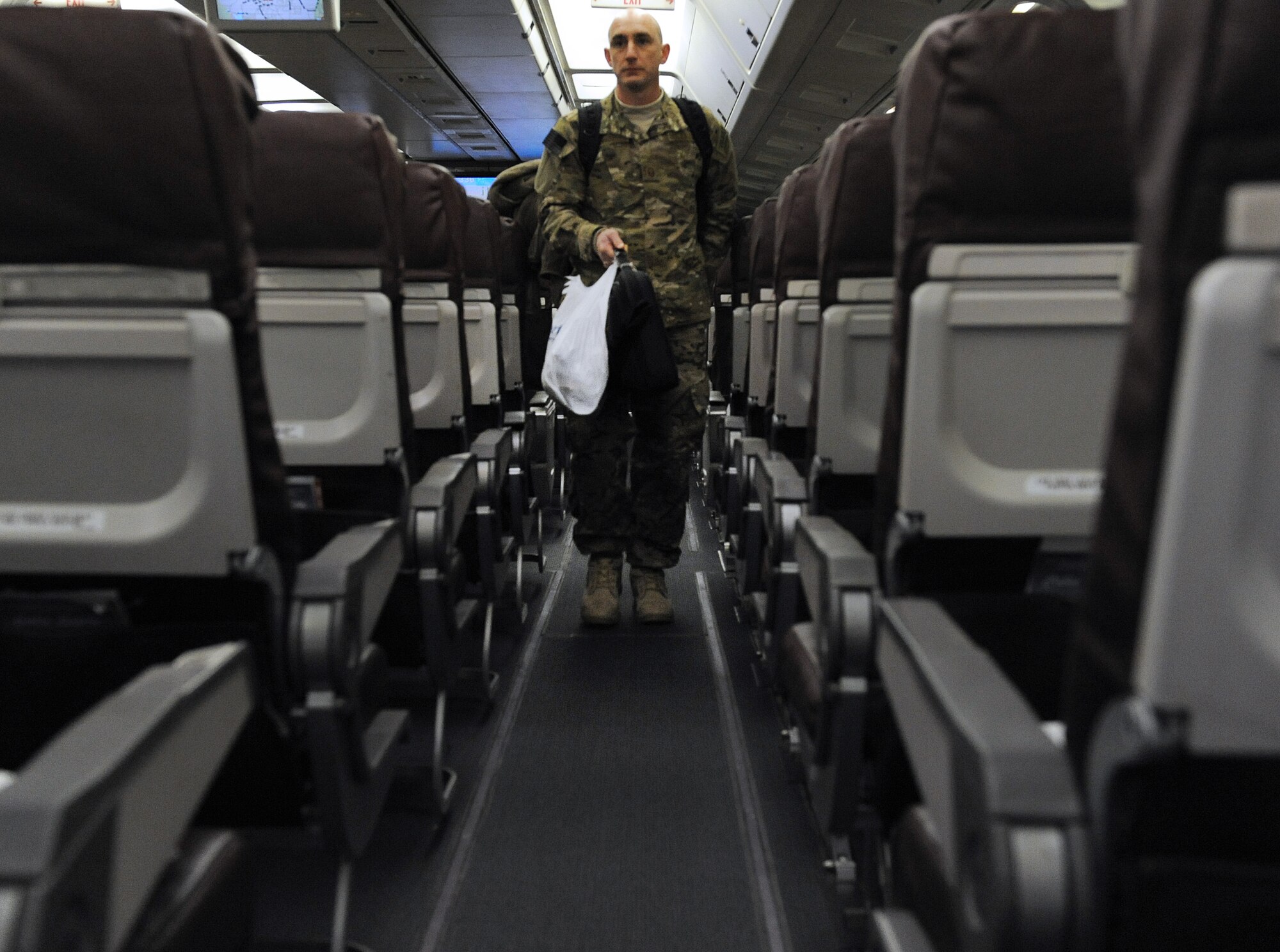 Master Sgt. Michael Odonnell, a 19th Aircraft Maintenance Squadron pro superintendent, boards a chartered passenger airliner Jan. 7, 2013, at Little Rock Air Force Base, Ark.  Following months of preparation, military members from LRAFB deployed to Southwest Asia. (U.S. Air Force photo by Tech. Sgt. Chad Chisholm)