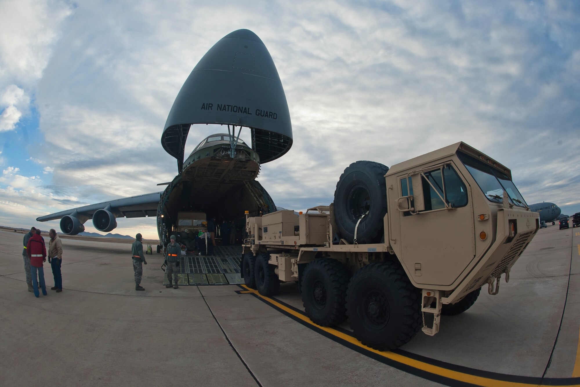 ALTUS AIR FORCE BASE, Okla. – Members of the 97th Air Mobility Wing, Kentucky Air Guard Contingency Response Group, 31st Air Defense Artillery Army Brigade, Fort Sill, Okla. and 167th Airlift Wing, Martinsburg, W. Va., unload an M984 Wrecker from a 167th AW C-5 Galaxy on the Altus AFB flight line, Jan. 4, 2013. The units joined forces to deploy batteries of Patriot-air-defense systems, more than two million pounds of equipment and about 300 personnel from 3-2 Air Defense Artillery Battalion to Turkey in support of the North Atlantic Treaty Organization. (U.S. Air Force photo by Airman 1st Class Levin Boland / Released)
