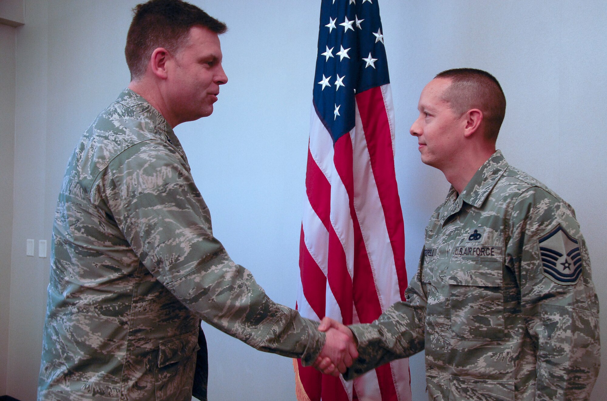 Col. Scott Brewer, 314th Airlift Wing commander, congratulates Master Sgt. George Terrell, 314th Maintenance Group quality assurance avionics inspector, for the Combat Airlifter of the Week Dec. 17, at Little Rock Air Force Base. Terrell devised and implemented the 314th MXG’s inspection and evaluation plan, which exceeded required monthly inspections by 22 percent, as well as, validated quality maintenance on 28 C-130H/J aircraft.  (U.S. Air Force photo by Airman 1st Class Regina Agoha)
